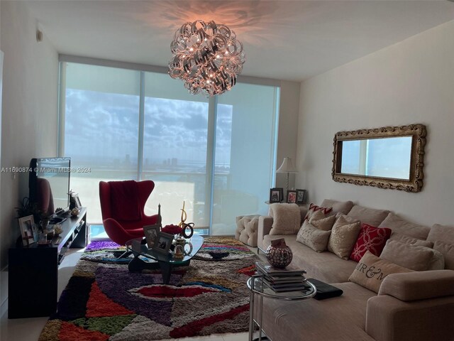 living room featuring expansive windows and a notable chandelier