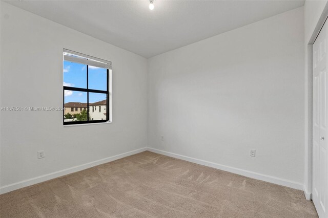 empty room featuring light colored carpet