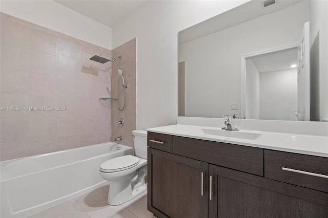 full bathroom featuring vanity, tile patterned floors, toilet, and tiled shower / bath