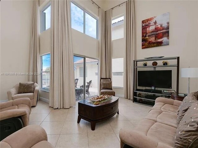 tiled living room with a high ceiling