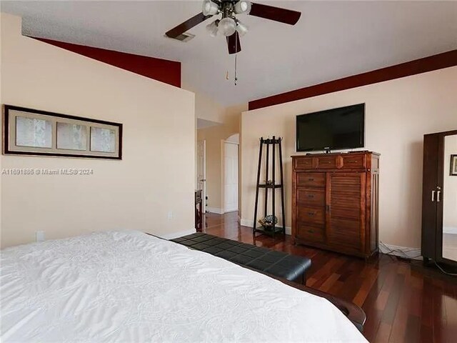 bedroom with dark hardwood / wood-style flooring, ceiling fan, and vaulted ceiling