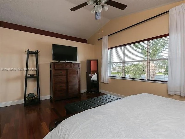 bedroom with vaulted ceiling, ceiling fan, and dark hardwood / wood-style floors