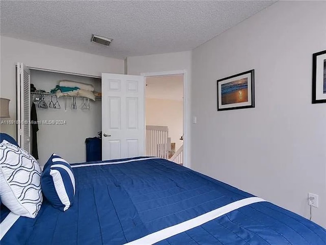 unfurnished bedroom with a closet and a textured ceiling