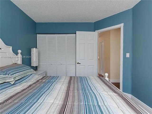 bedroom with a closet and a textured ceiling