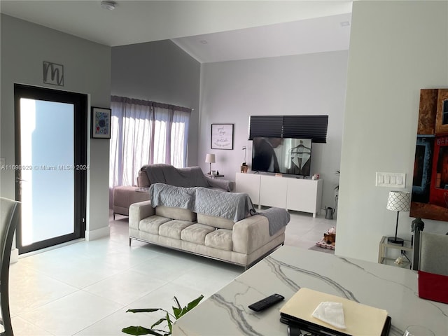 tiled living room featuring a towering ceiling