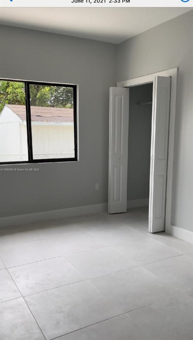 unfurnished bedroom featuring light tile patterned flooring