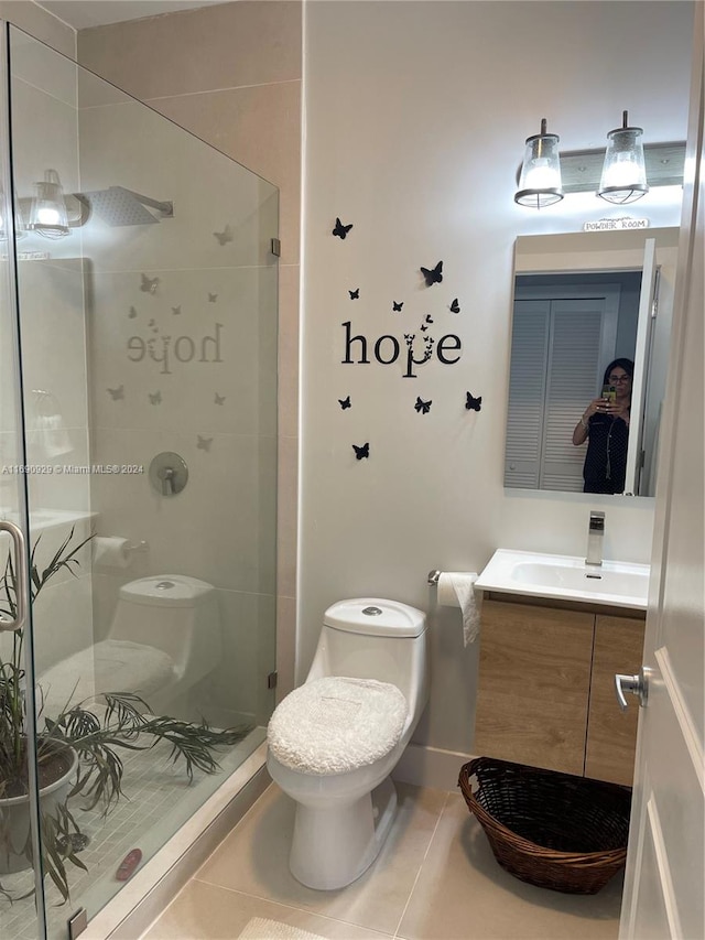 bathroom with vanity, tile patterned flooring, toilet, and an enclosed shower