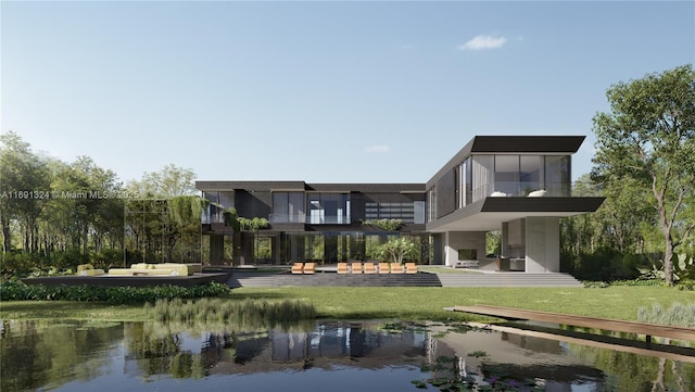 back of house featuring a lawn, a water view, and a balcony