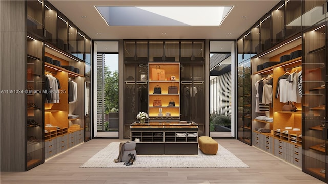 mudroom with a skylight and light hardwood / wood-style floors