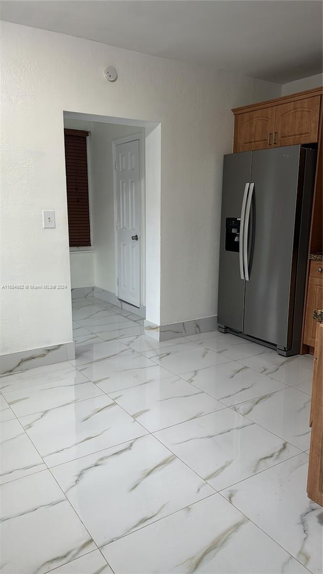 kitchen featuring stainless steel fridge with ice dispenser