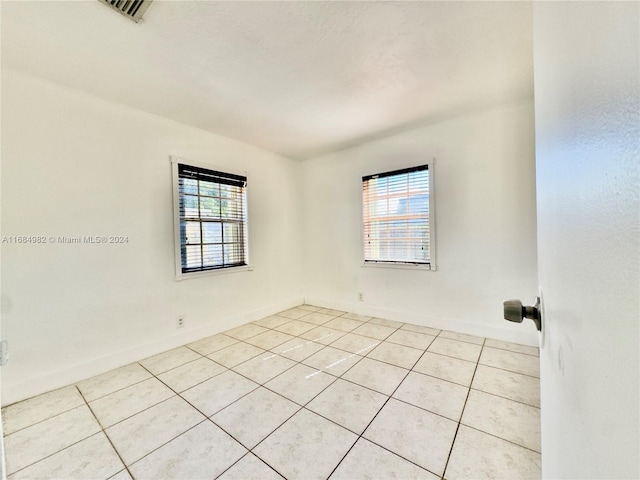 spare room with light tile patterned floors