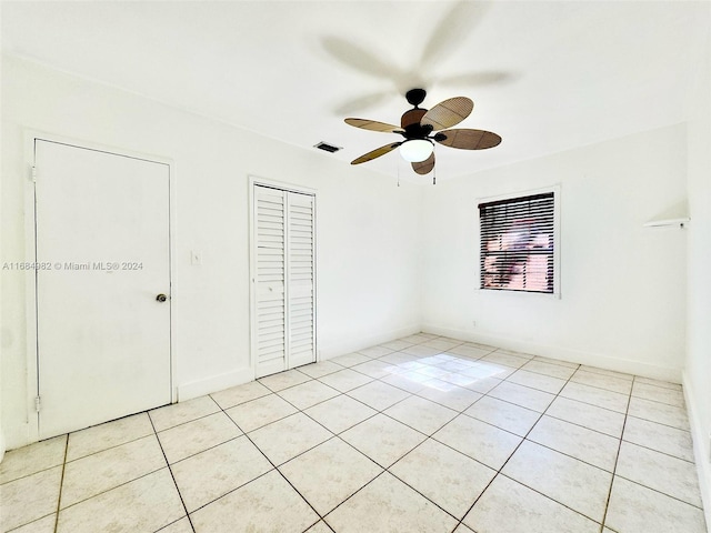 unfurnished bedroom with light tile patterned floors and ceiling fan