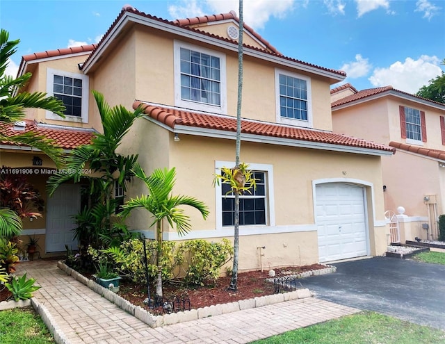 mediterranean / spanish home with a garage