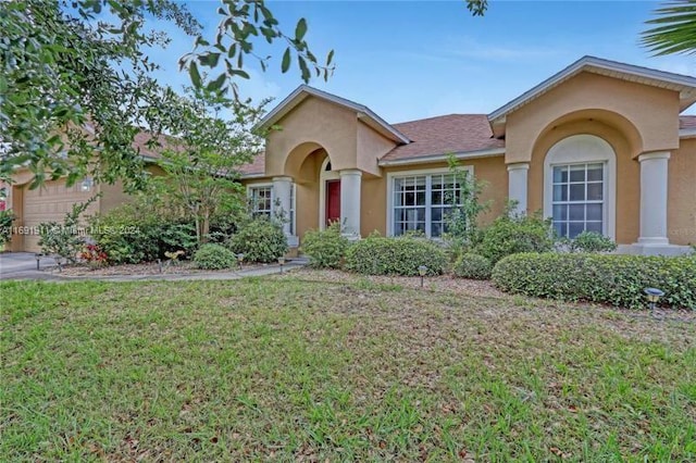 view of front of house with a garage and a front lawn