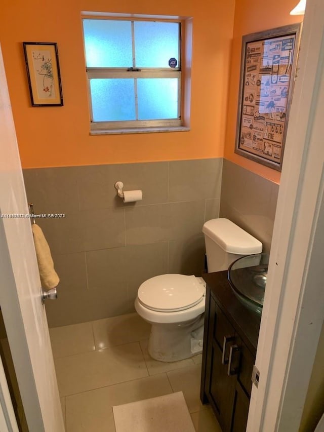 bathroom featuring tile walls, tile patterned flooring, vanity, and toilet