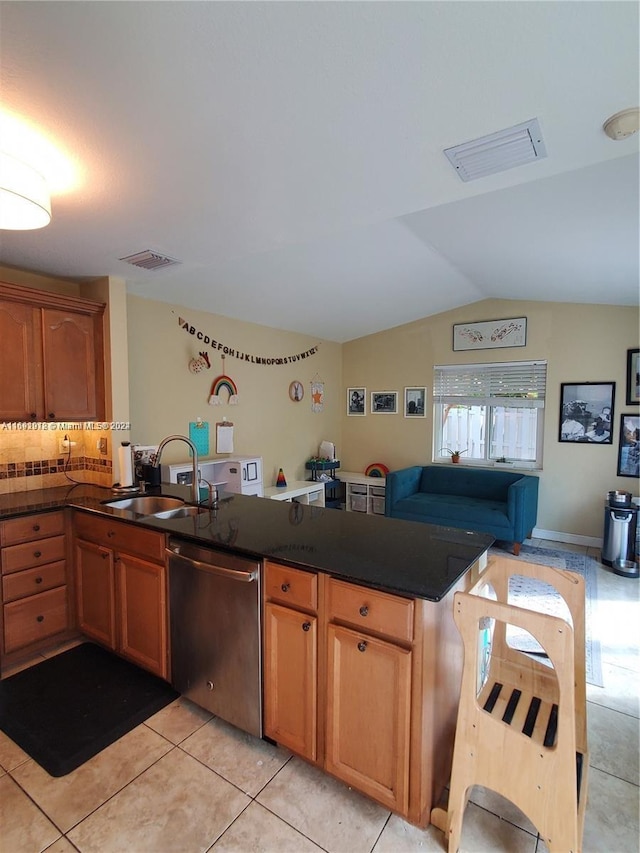 kitchen with dishwasher, lofted ceiling, sink, and light tile patterned flooring