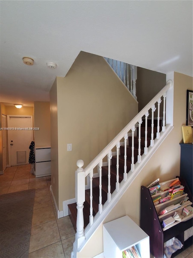 staircase featuring tile patterned floors