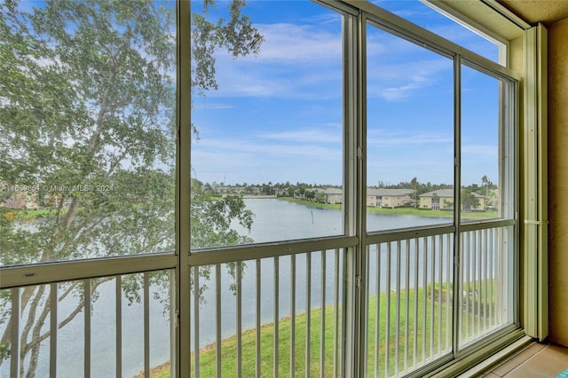 unfurnished sunroom featuring a water view and a healthy amount of sunlight