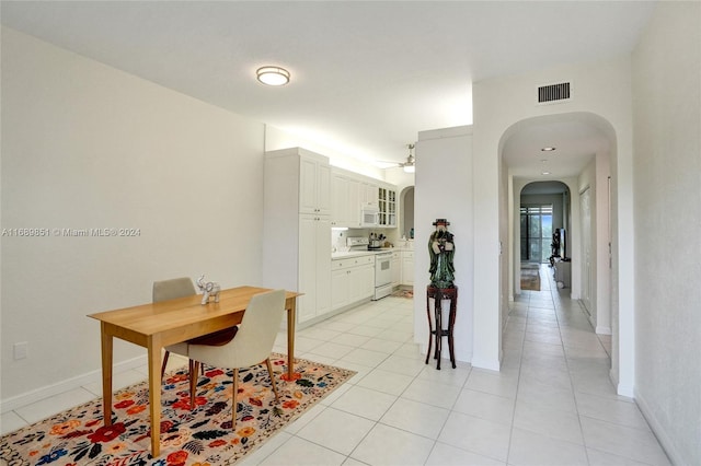 interior space featuring ceiling fan and light tile patterned floors