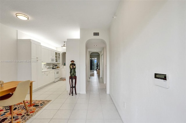 hall with light tile patterned floors