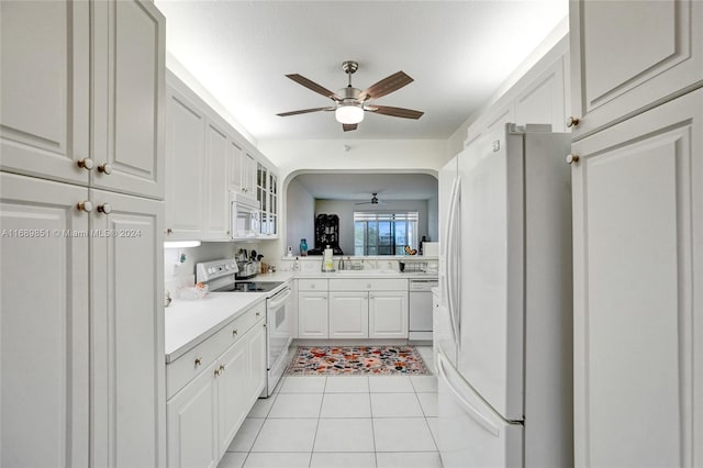 kitchen featuring ceiling fan, sink, white cabinets, white appliances, and light tile patterned floors