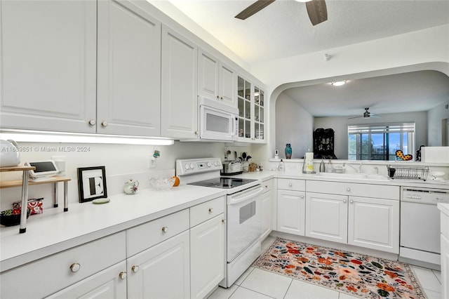 kitchen featuring white cabinets, white appliances, sink, and light tile patterned flooring