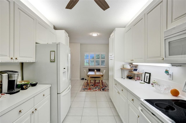 kitchen with ceiling fan, white cabinetry, light tile patterned flooring, and white appliances