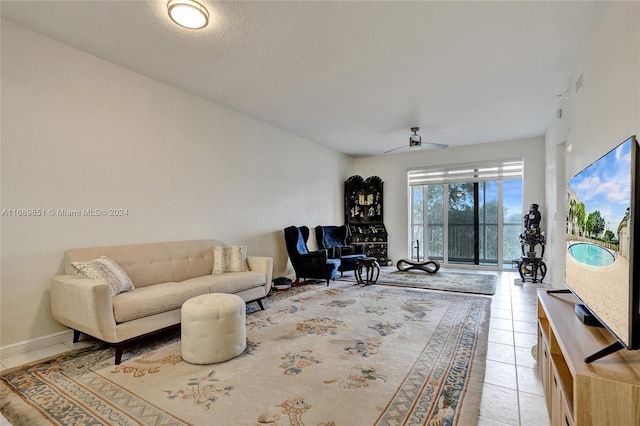 tiled living room with ceiling fan