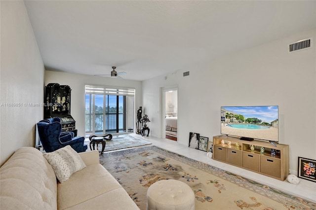 living room with ceiling fan and light tile patterned flooring