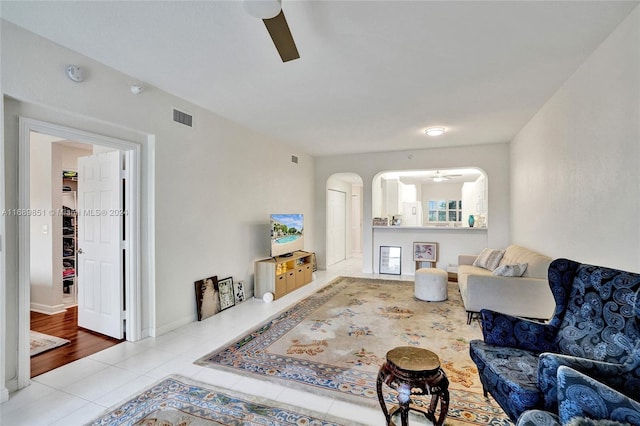 living room with ceiling fan and light wood-type flooring