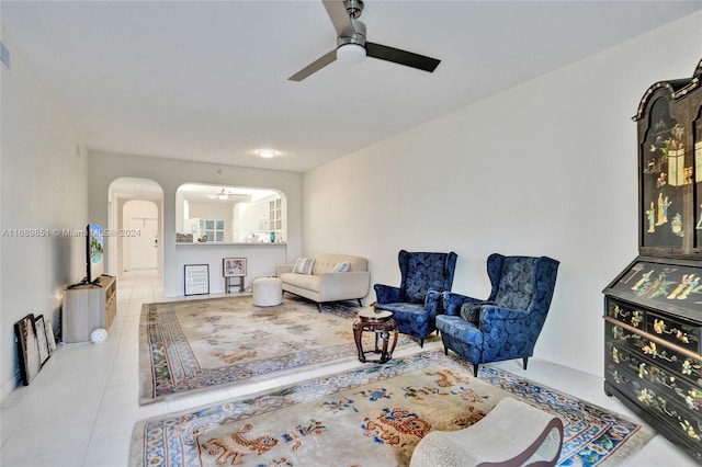 tiled living room featuring ceiling fan