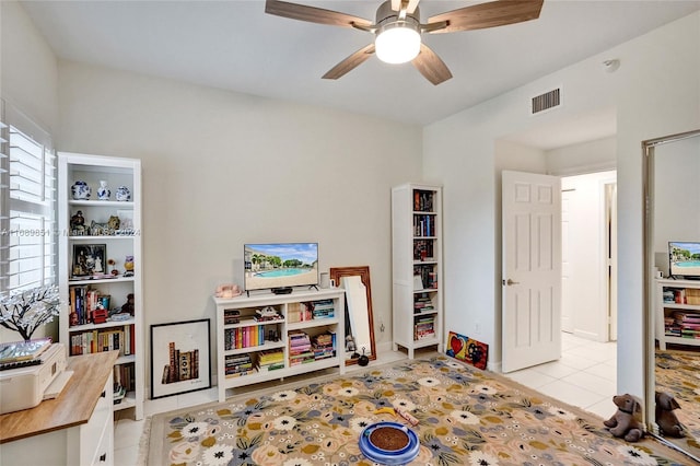 tiled bedroom featuring ceiling fan