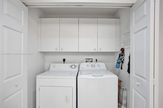 laundry area with cabinets and separate washer and dryer