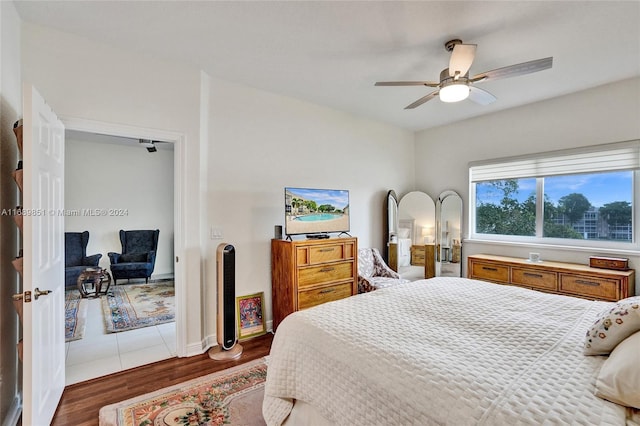 bedroom with ceiling fan and dark wood-type flooring