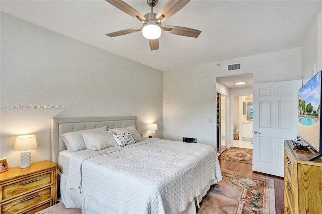 bedroom featuring a closet, ceiling fan, hardwood / wood-style floors, and ensuite bathroom