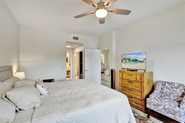 bedroom with ceiling fan and ensuite bath