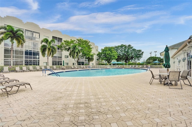 view of swimming pool featuring a patio area