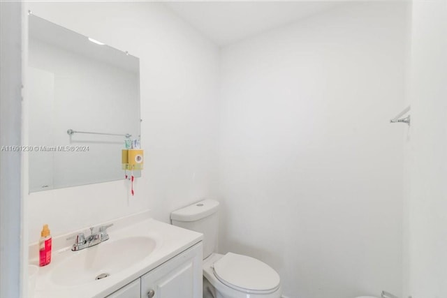 bathroom with toilet and vanity