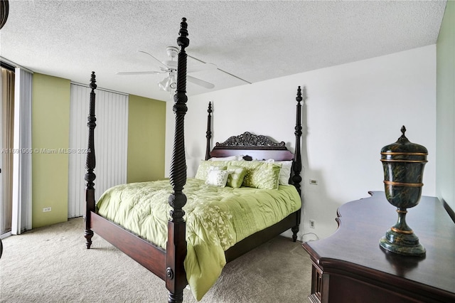 bedroom with ceiling fan, light colored carpet, and a textured ceiling