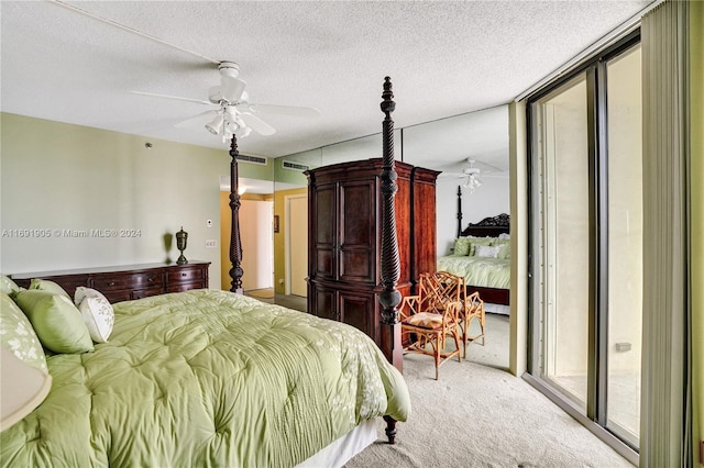 carpeted bedroom featuring access to exterior, a textured ceiling, and ceiling fan