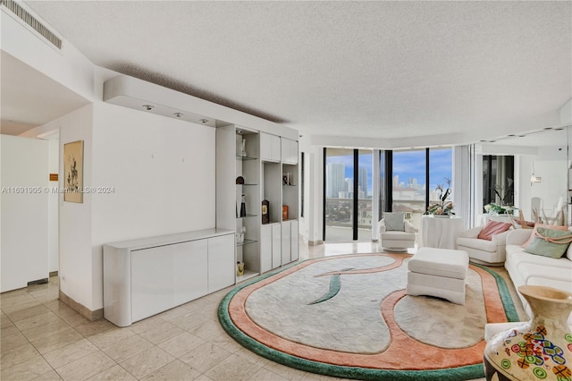 living room with a textured ceiling and expansive windows