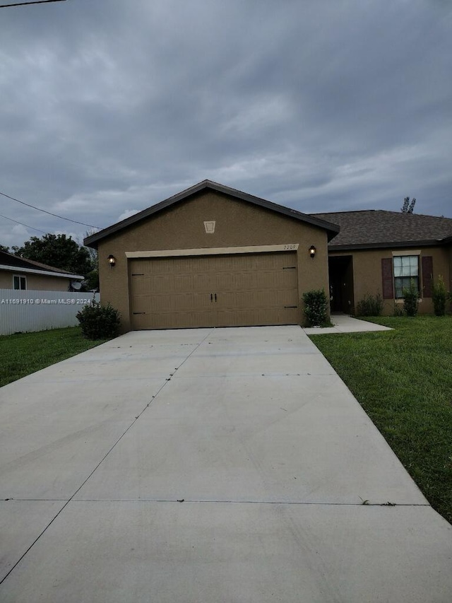 single story home with a front lawn and a garage