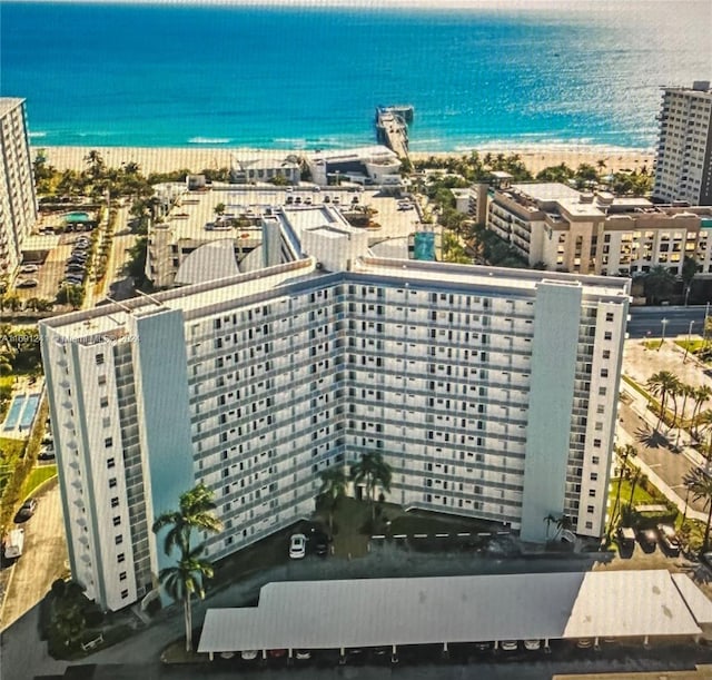 drone / aerial view featuring a view of the beach and a water view