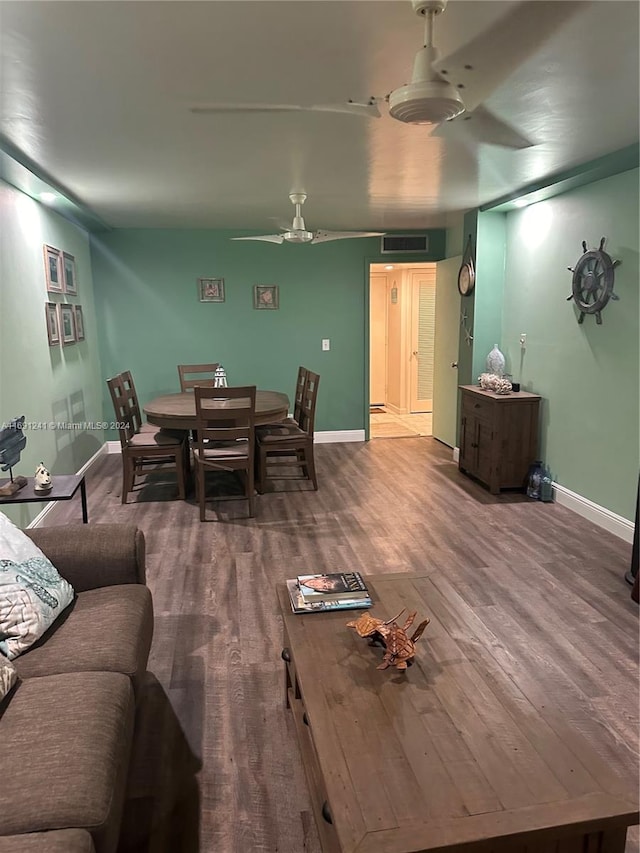 living room with hardwood / wood-style flooring and ceiling fan