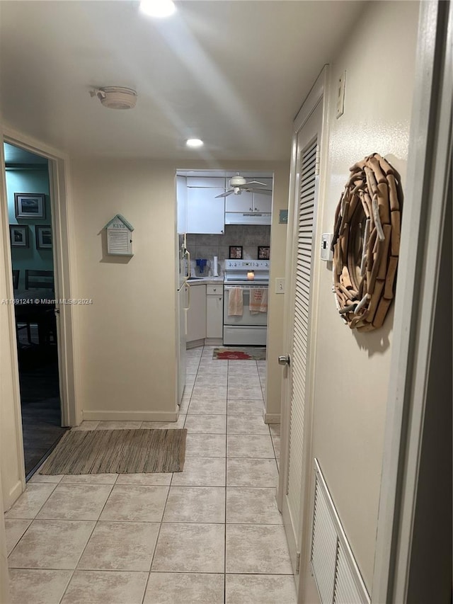 hall with light tile patterned flooring