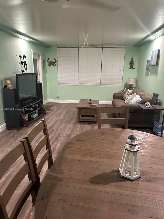 dining area with hardwood / wood-style floors and ceiling fan