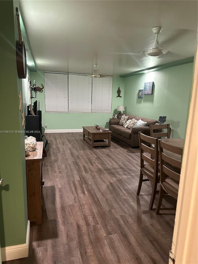 living room with ceiling fan and dark hardwood / wood-style floors