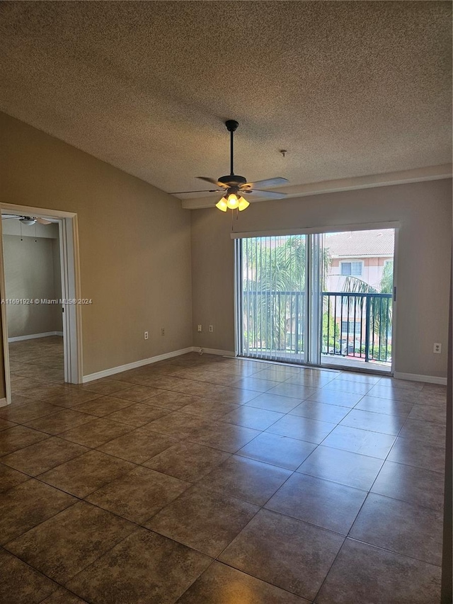 tiled empty room with a textured ceiling and ceiling fan