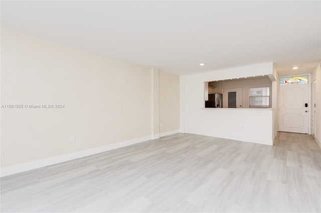 unfurnished living room with light wood-type flooring