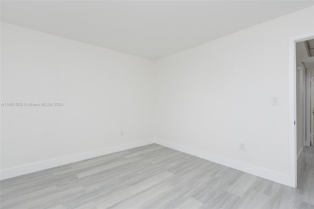 unfurnished room with light wood-type flooring